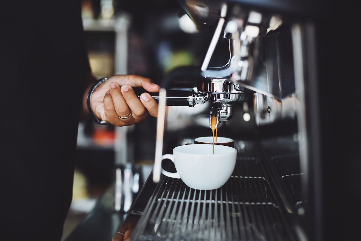 Barista pulling an espresso shot from a professional coffee machine