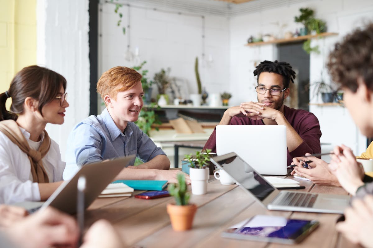 Team of employees collaborating around a table in a modern office environment