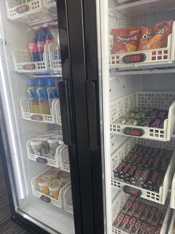 Smart fridge vending machine double door with cold drinks and snacks including Doritos and Starbucks coffee