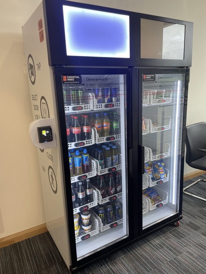 Smart vending machine with contactless reader in office breakroom
