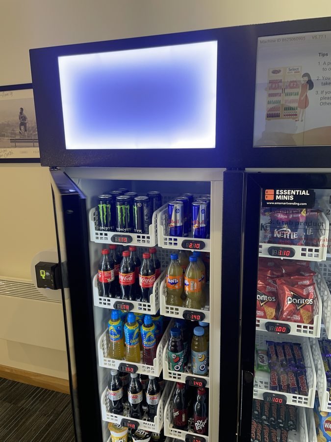 Smart vending machine side view showing drinks and snacks selection