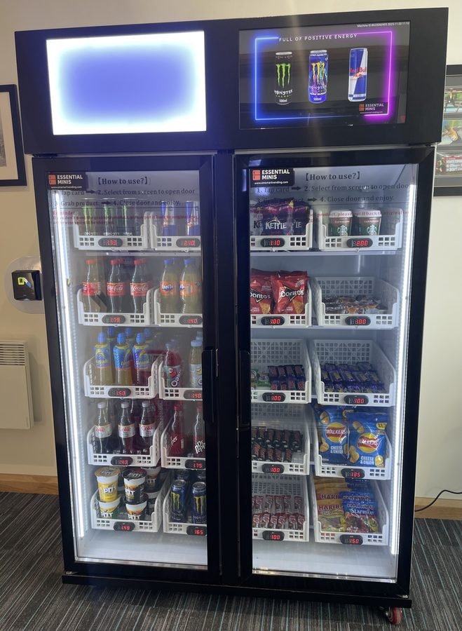 Smart vending machine fully stocked with drinks and snacks in an office workplace